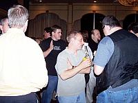 Jimmy Cooper doing the karate chop, Bruce Golub drinking a beer talking to Joe Monks - Pamela's hubby